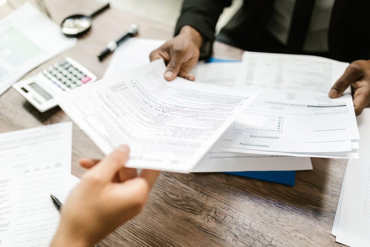 Claim documents handed across a desk